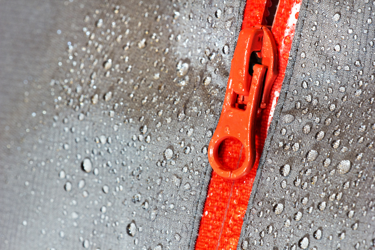 Rain beading on a runner's waterproof jacket